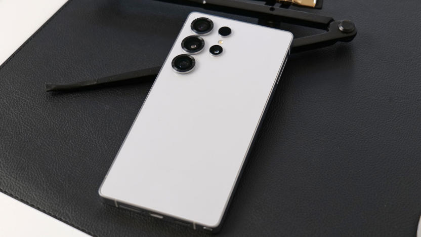 A white phone on a black surface.