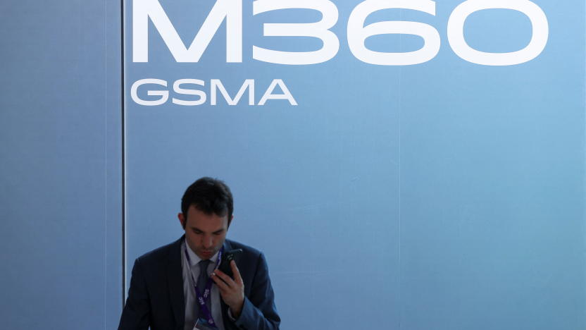 A man uses a mobile phone, as he attends the Mobile World Congress (MWC) in Barcelona, Spain, February 27, 2024. REUTERS/Bruna Casas