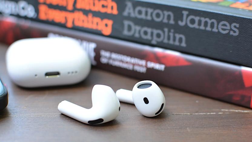 Some earbuds in front of books.