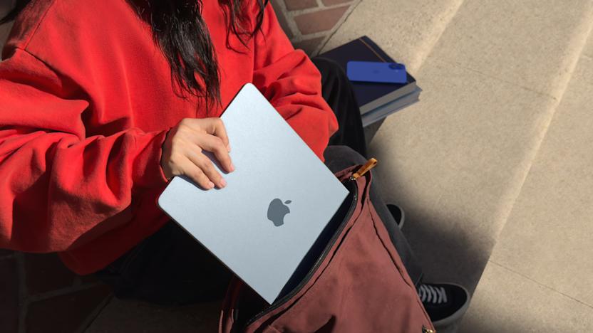 Lifestyle marketing photo of a person sliding the MacBook Air into a backpack.