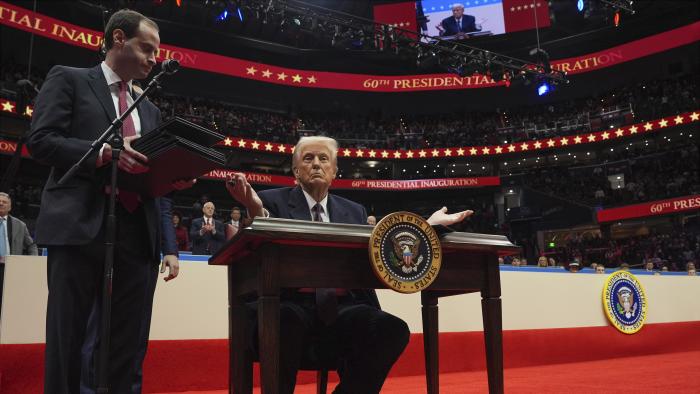 President Donald Trump finishes signing executive orders as he attends an indoor Presidential Inauguration parade event at Capital One Arena, Monday, Jan. 20, 2025, in Washington. (AP Photo/Evan Vucci)